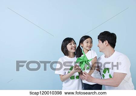 A family wearing recycling shirt with green pinwheel View Large Photo Image Stock Photo - A family wearing recycling shirt with green pinwheel. Fotosearch