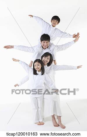 Stock Image - A family with their arms open. Fotosearch