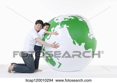A father and daughter hugging a green globe View Large Photo Image Picture - A father and daughter hugging a green globe. Fotosearch