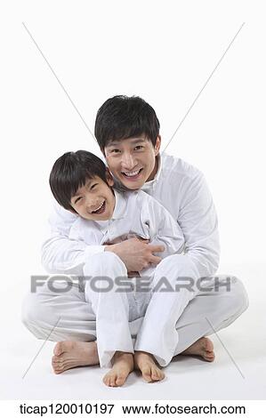 A father and son hugging together View Large Photo Image Stock Photo - A father and son hugging together. Fotosearch