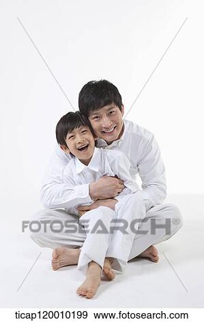 A father and son hugging together View Large Photo Image Stock Photo - A father and son hugging together. Fotosearch