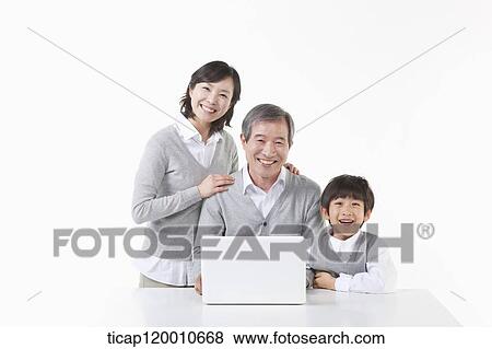 Stock Photo - A father and son hugging together. Fotosearch