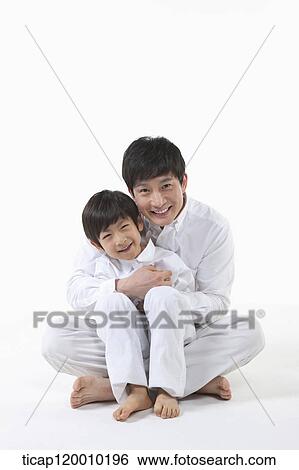 A father and son hugging together View Large Photo Image Stock Photograph - A father and son hugging together. Fotosearch