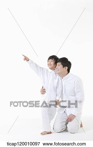 Stock Photo - A father and son looking at the sky . Fotosearch