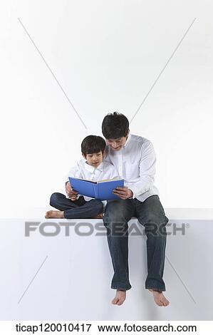 A father and son reading a book View Large Photo Image Stock Photo - A father and son reading a book. Fotosearch