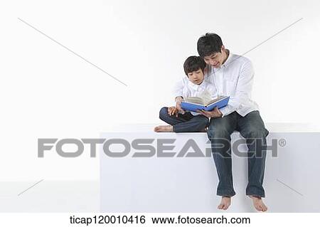 A father and son reading a book View Large Photo Image Stock Photograph - A father and son reading a book. Fotosearch