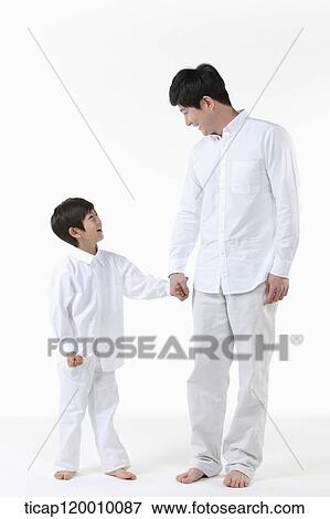 A father and son smiling at each other View Large Photo Image Stock Photo - A father and son smiling at each other. Fotosearch