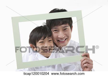 Picture - A father and son with a green frame. Fotosearch