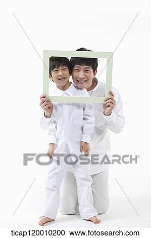 A father and son with a green frame View Large Photo Image Stock Image - A father and son with a green frame. Fotosearch