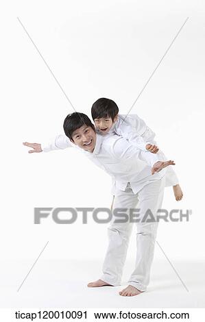 Stock Image - A father playing with his son on the back. Fotosearch