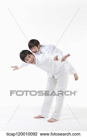 A father playing with his son on the back View Large Photo Image Stock Image - A father playing with his son on the back. Fotosearch