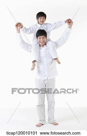 A father putting his son on his shoulders View Large Photo Image Stock Image - A father putting his son on his shoulders. Fotosearch
