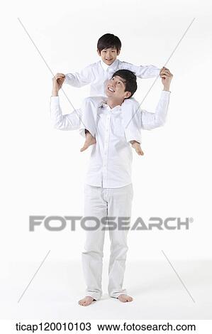 A father putting his son on his shoulders View Large Photo Image Stock Image - A father putting his son on his shoulders. Fotosearch