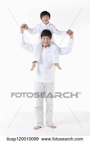 A father putting his son on his shoulders View Large Photo Image Stock Photo - A father putting his son on his shoulders. Fotosearch