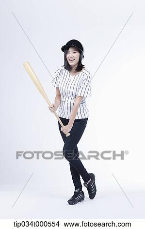 A female baseball player with a bat View Large Photo Image Picture - A female baseball player with a bat. Fotosearch