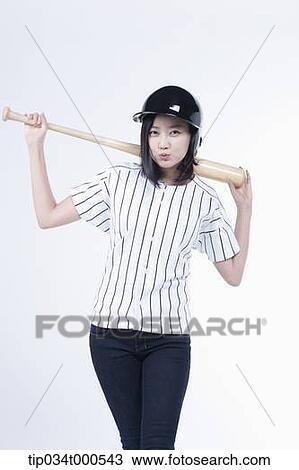 Stock Image - A female baseball player with a bat. Fotosearch