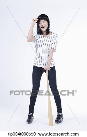Stock Image - A female baseball player with a bat. Fotosearch