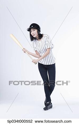 Stock Image - A female baseball player with a bat. Fotosearch