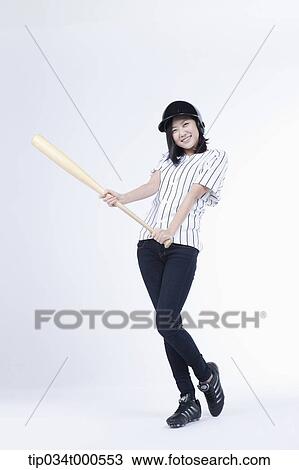 Stock Image - A female baseball player with a bat. Fotosearch