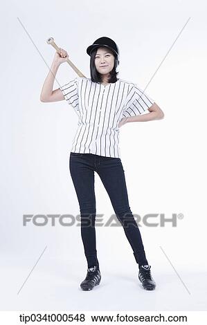 Stock Photo - A female baseball player with a bat. Fotosearch
