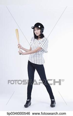 Stock Photograph - A female baseball player with a bat. Fotosearch