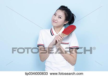 Stock Image - A female ping-pong player with a racket. Fotosearch