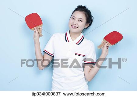 Stock Photo - A female ping-pong player with rackets . Fotosearch