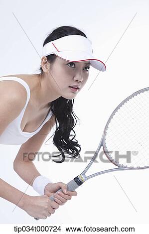 A female tennis player holding a racket View Large Photo Image Picture - A female tennis player holding a racket. Fotosearch