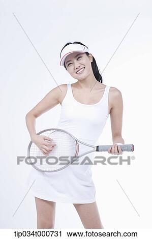 Stock Image - A female tennis player playing the racket. Fotosearch