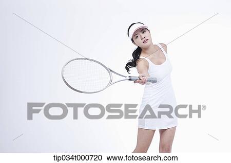 A female tennis player swing a racket View Large Photo Image Stock Image - A female tennis player swing a racket. Fotosearch