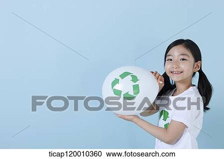 Stock Image - A girl blowing a recycling balloon . Fotosearch