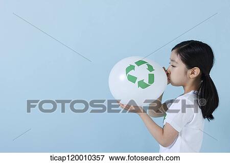A girl blowing a recycling balloon View Large Photo Image Stock Photo - A girl blowing a recycling balloon . Fotosearch