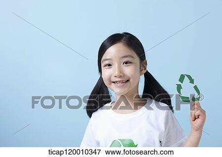 Stock Photo - A girl holding a recycling symbol . Fotosearch