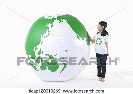 A girl in recycling shirt and a green globe View Large Photo Image Stock Photo - A girl in recycling shirt and a green globe. Fotosearch