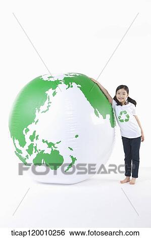 A girl in recycling shirt and a green globe View Large Photo Image Stock Photograph - A girl in recycling shirt and a green globe. Fotosearch