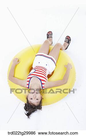 Stock Photograph - a girl lying on the tube. Fotosearch