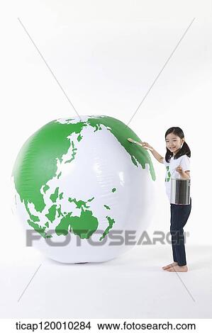 Picture - A girl painting a green globe. Fotosearch