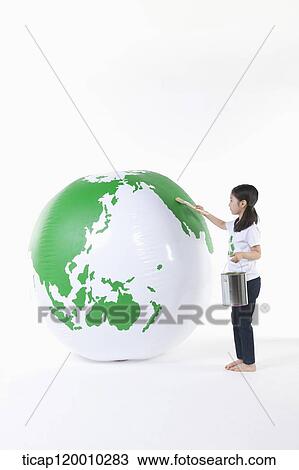 A girl painting a green globe View Large Photo Image Stock Image - A girl painting a green globe. Fotosearch