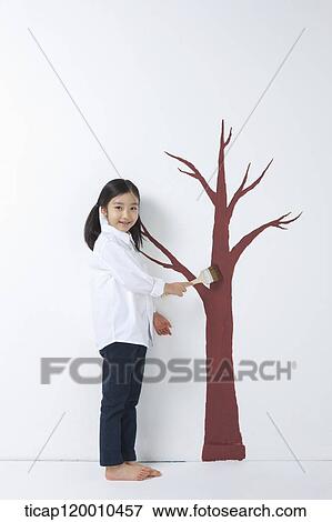 A girl painting the tree View Large Photo Image Stock Photo - A girl painting the tree. Fotosearch