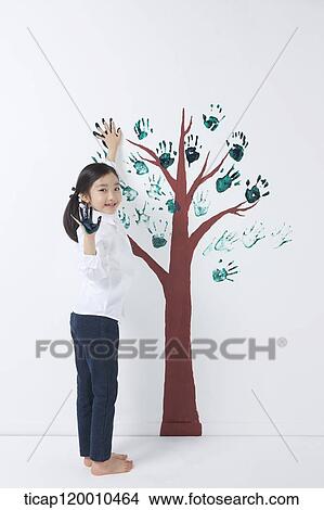 A girl painting the tree with hands View Large Photo Image Picture - A girl painting the tree with hands. Fotosearch