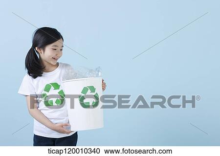 A girl smiling with recycling bin View Large Photo Image Stock Image - A girl smiling with recycling bin . Fotosearch