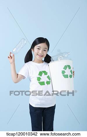 A girl smiling with recycling bin View Large Photo Image Stock Image - A girl smiling with recycling bin . Fotosearch