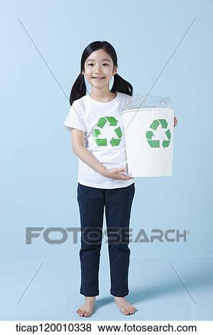 A girl smiling with recycling bin View Large Photo Image Stock Photo - A girl smiling with recycling bin . Fotosearch