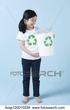 A girl smiling with recycling bin View Large Photo Image Stock Photo - A girl smiling with recycling bin . Fotosearch