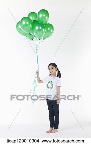 A girl wearing recycling shirt with green balloons View Large Photo Image Picture - A girl wearing recycling shirt with green balloons. Fotosearch