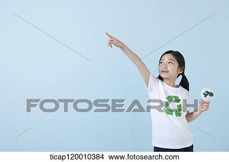 Picture - A girl wearing recycling shirt with globe light bulb. Fotosearch