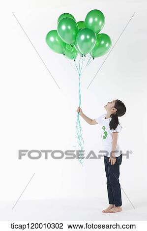 A girl wearing recycling shirt with green balloons View Large Photo Image Stock Image - A girl wearing recycling shirt with green balloons. Fotosearch