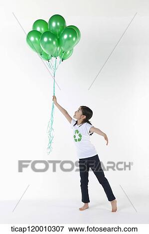 A girl wearing recycling shirt with green balloons View Large Photo Image Stock Photo - A girl wearing recycling shirt with green balloons. Fotosearch