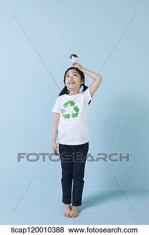 A girl wearing recycling shirt with globe light bulb View Large Photo Image Stock Photo - A girl wearing recycling shirt with globe light bulb. Fotosearch