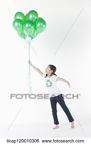 A girl wearing recycling shirt with green balloons View Large Photo Image Stock Photograph - A girl wearing recycling shirt with green balloons. Fotosearch
